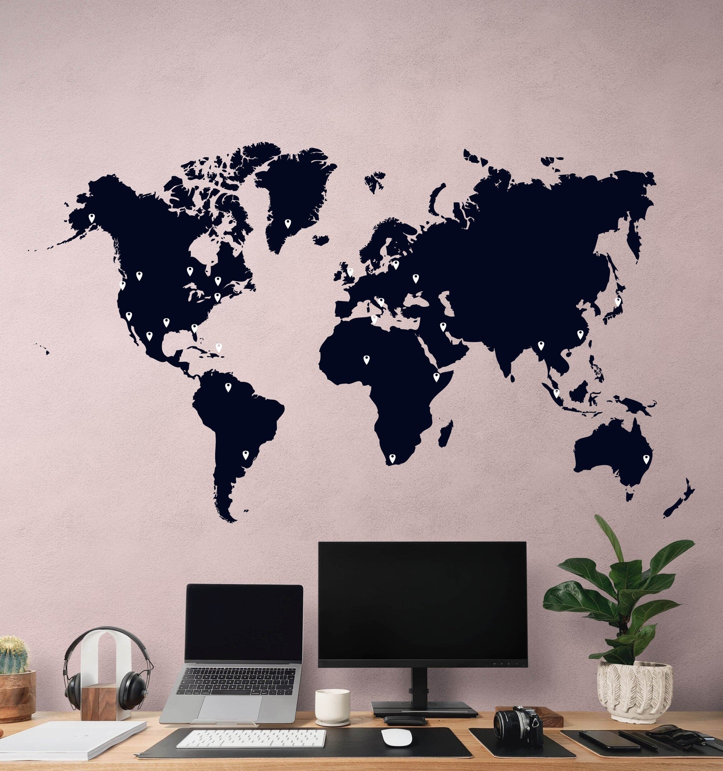 Office wall adorned with black world map decal.