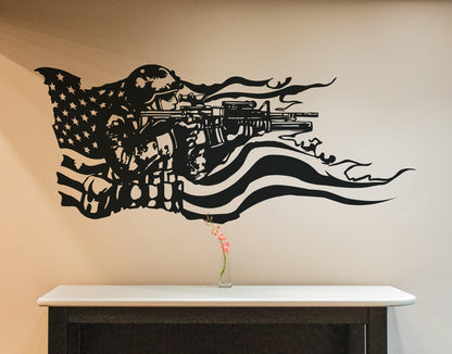 A black decal on a white wall showing a soldier holding a gun and the American flag behind it. Underneath it is a white table.