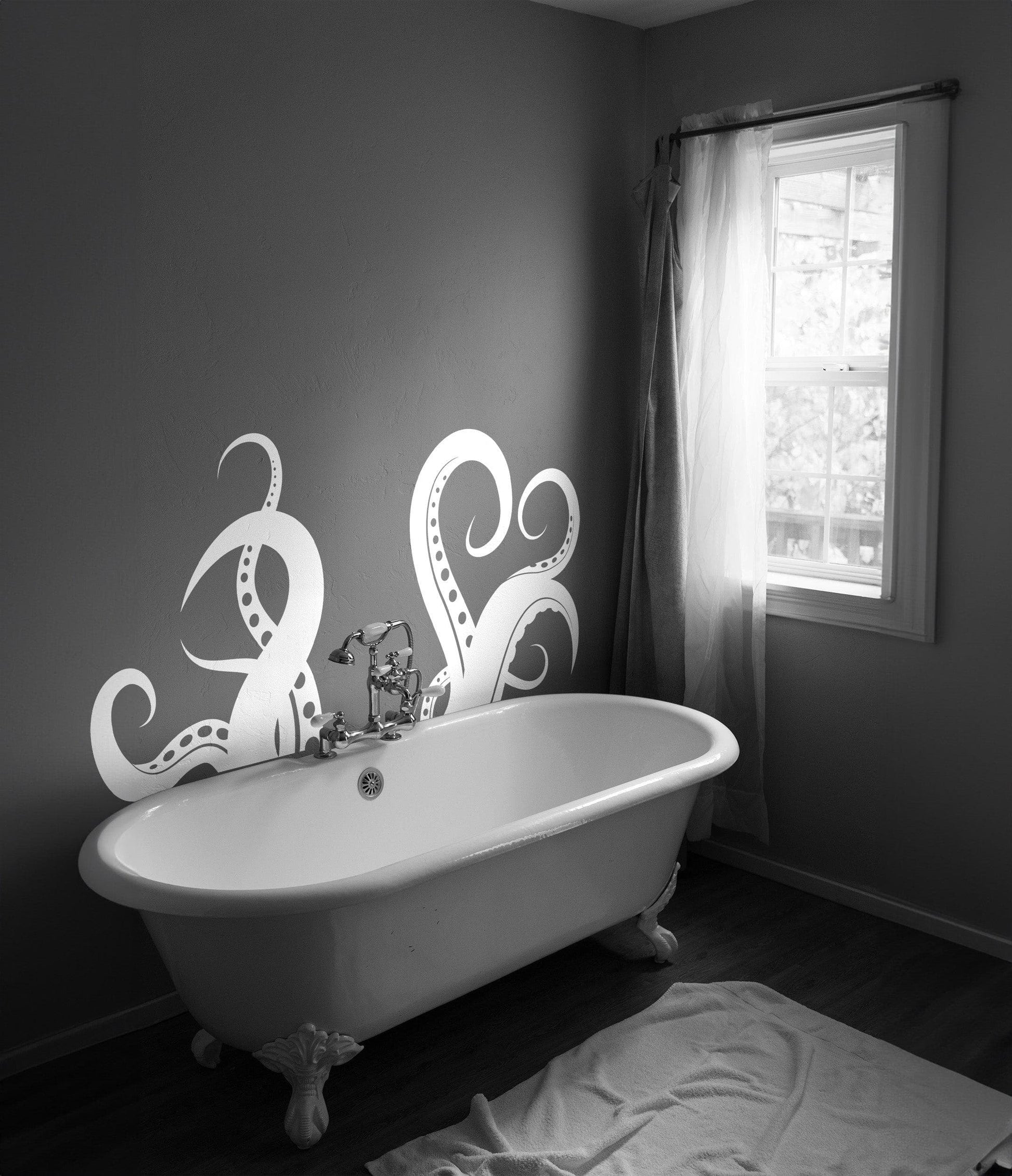 White octopus tentacles decal on a dark wall above a bathtub.