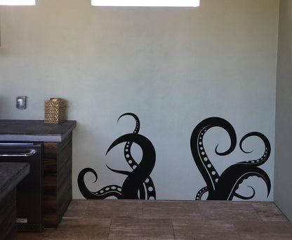 A black octopus tentacles decal on a white wall.