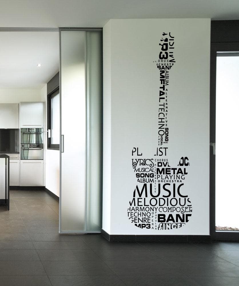 A black decal of a guitar with words on a white wall near a kitchen.
