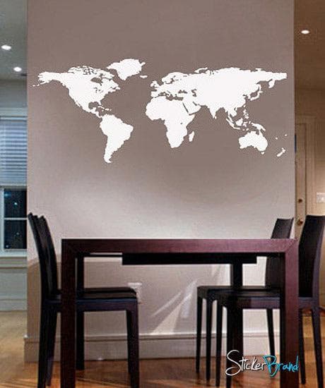 White world map decal on a gray wall in a dining room.