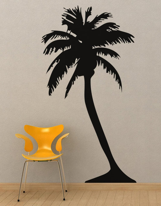Black palm tree decals on a white wall near a yellow chair.