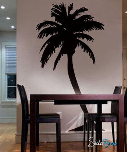 Black palm tree decals on a white wall in a dining room.