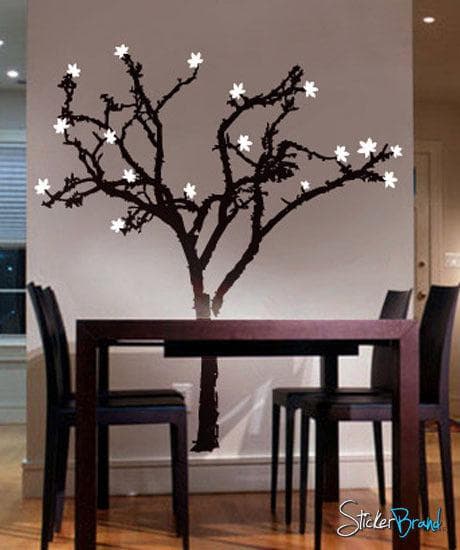 A black cherry blossom tree decal on a white wall in a dining room.