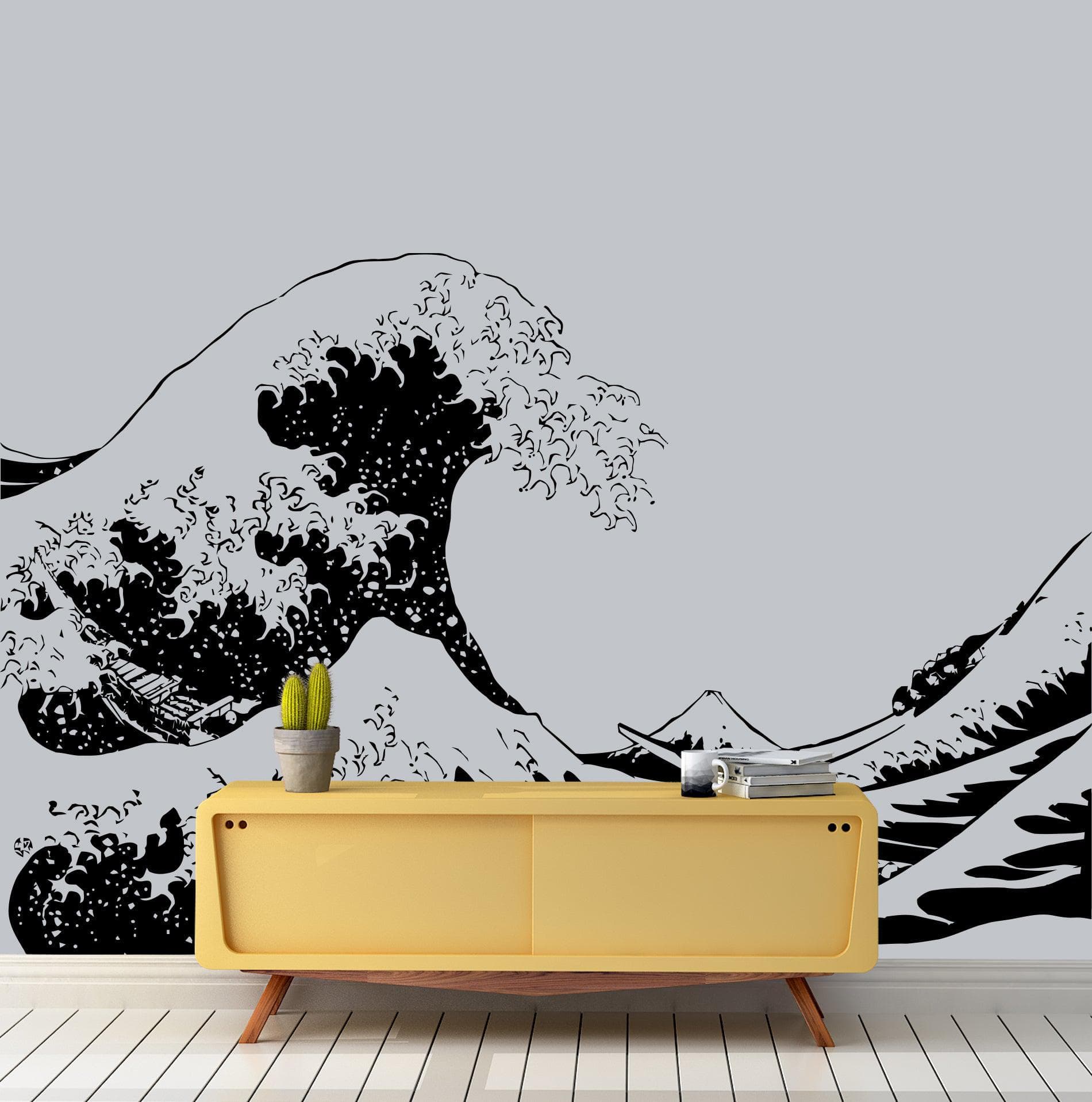 The Great Wave wall decal on a white wall above a yellow table.