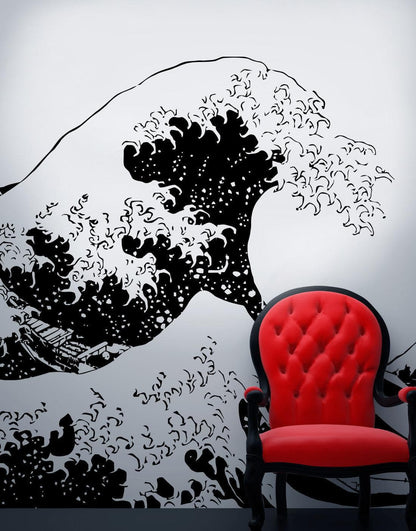 The Great Wave wall decal on a white wall, with a red chair in front of it.