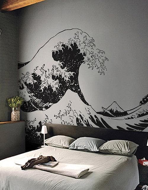 The Great Wave wall decal on a gray wall in a bedroom.