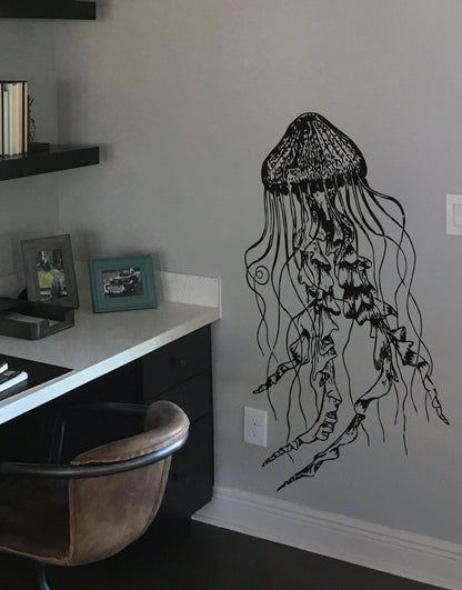 Black jellyfish decal on a white wall near a table.