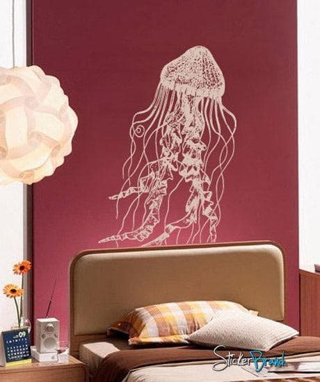 White jellyfish wall decal on a dark red wall in a bedroom.