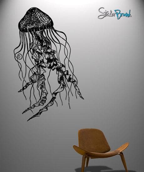 Black jellyfish decal on a white wall near a chair.