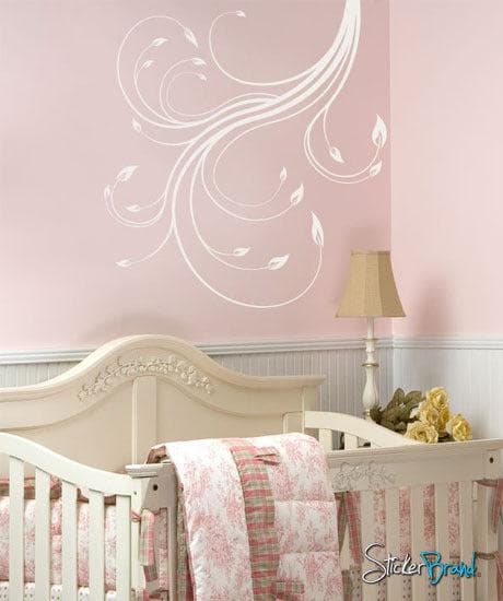 A white swirl decal on a pink background in a nursery.