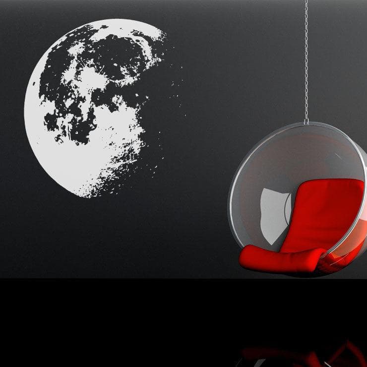 White moon decal on a black wall in a living room. 