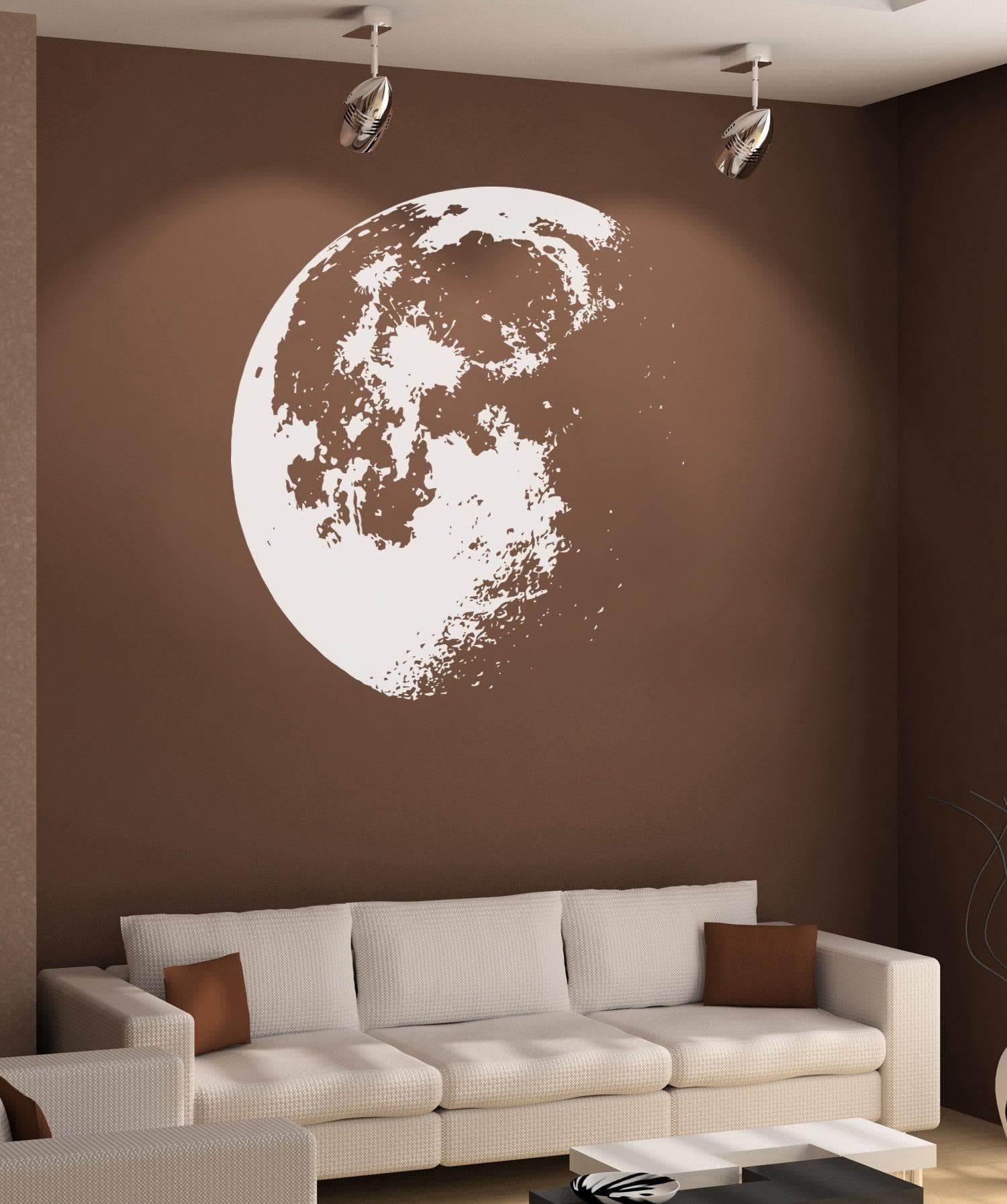 White moon decal on a brown wall in a living room. 