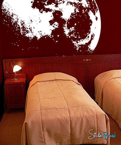 White moon decal on a red wall in a bedroom. 