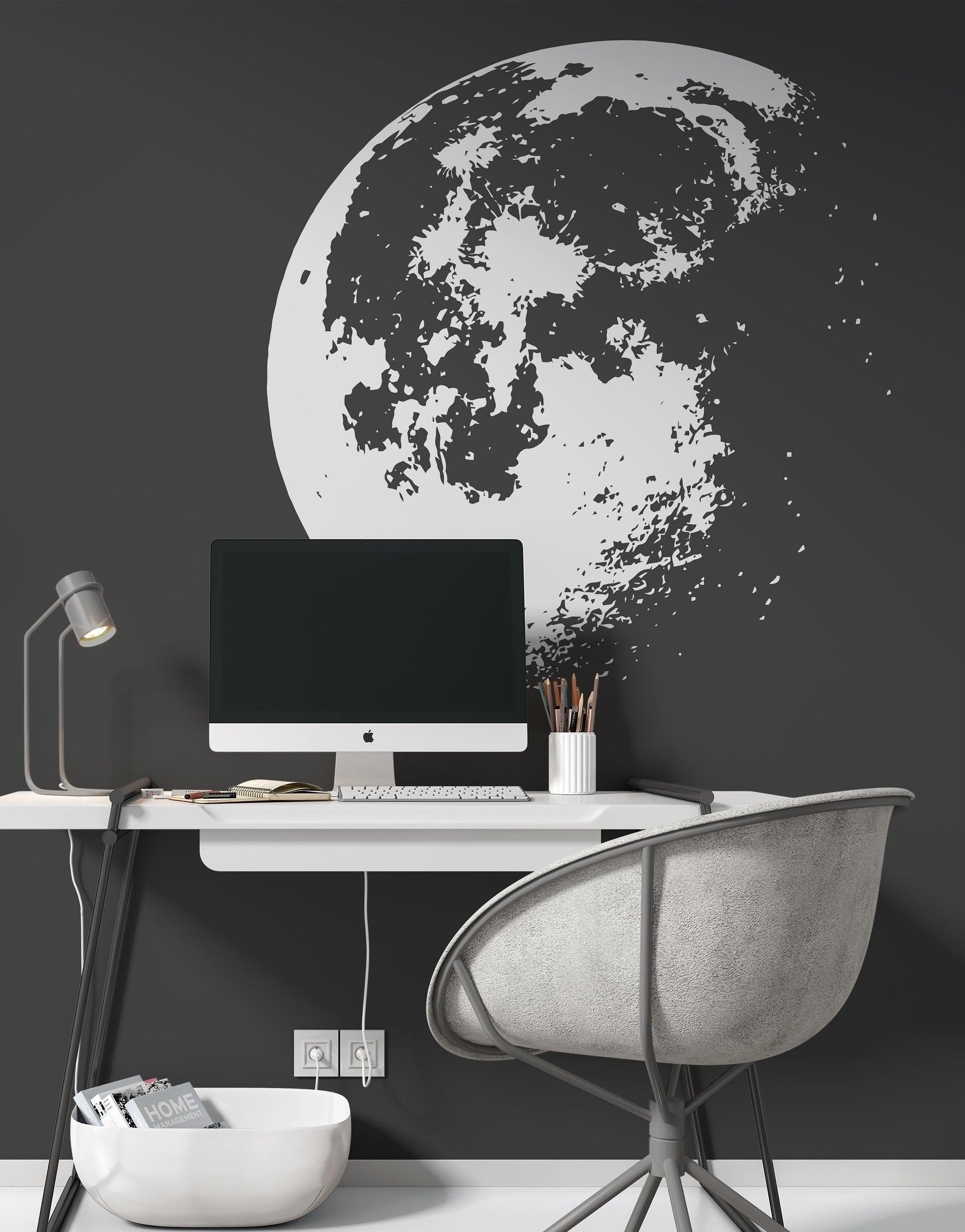 White moon decal on a black wall in an office. 