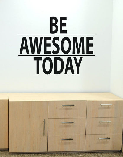 A black text decal saying "BE AWESOME TODAY" on a white wall over a brown cabinet.
