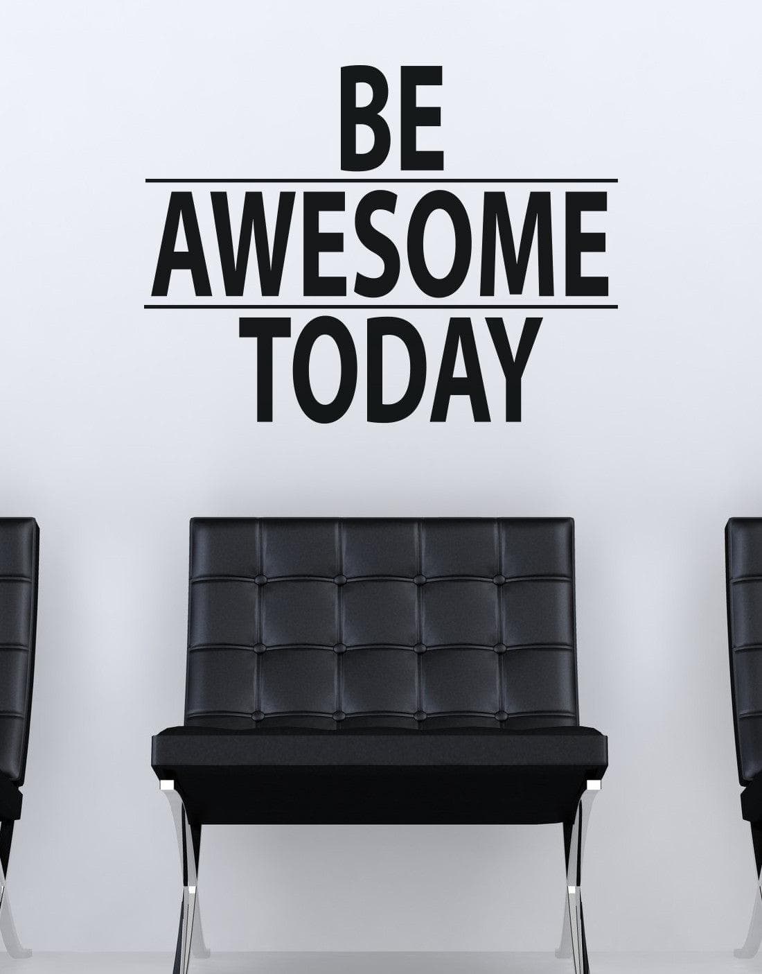 A black text decal saying "BE AWESOME TODAY" on a white wall over a black chair. 