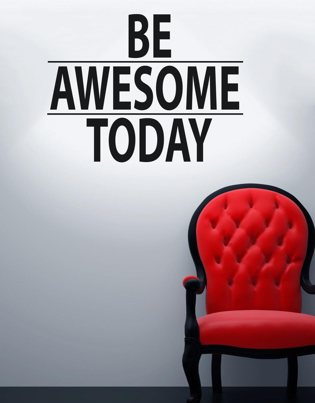 A black text decal saying "BE AWESOME TODAY" on a white wall over a red chair. 