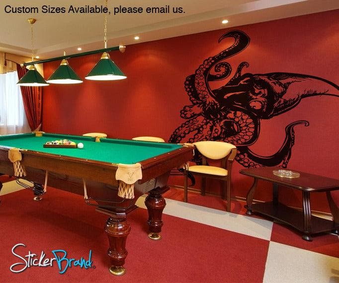 A black decal of a giant octopus on red wall.
