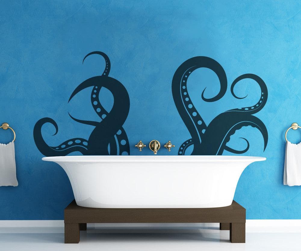 A black octopus tentacles decal on a blue wall above a white bathtub.