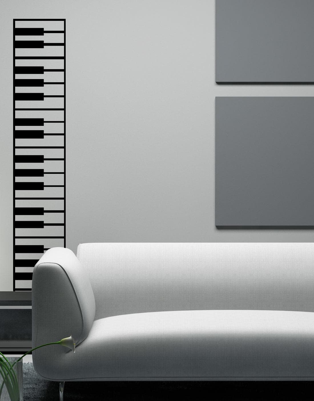A black decal of piano keys on a white wall near a white couch.