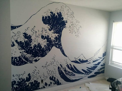 A blue Great Wave wall decal on a white wall.
