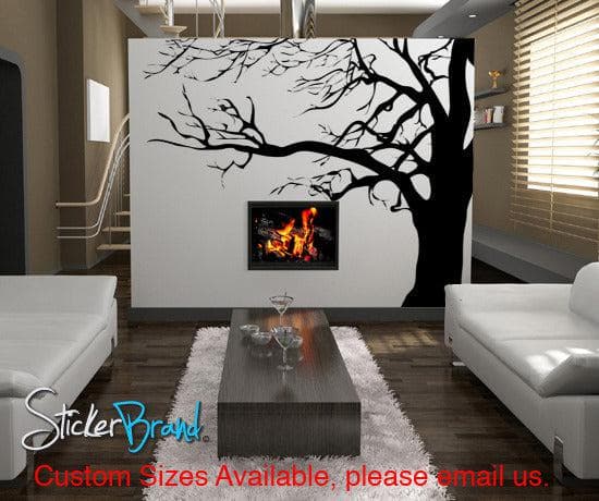 A black tree decal on a white wall in a living room.