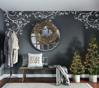 White swirling floral decals on a dark wall above a mirror and bench.