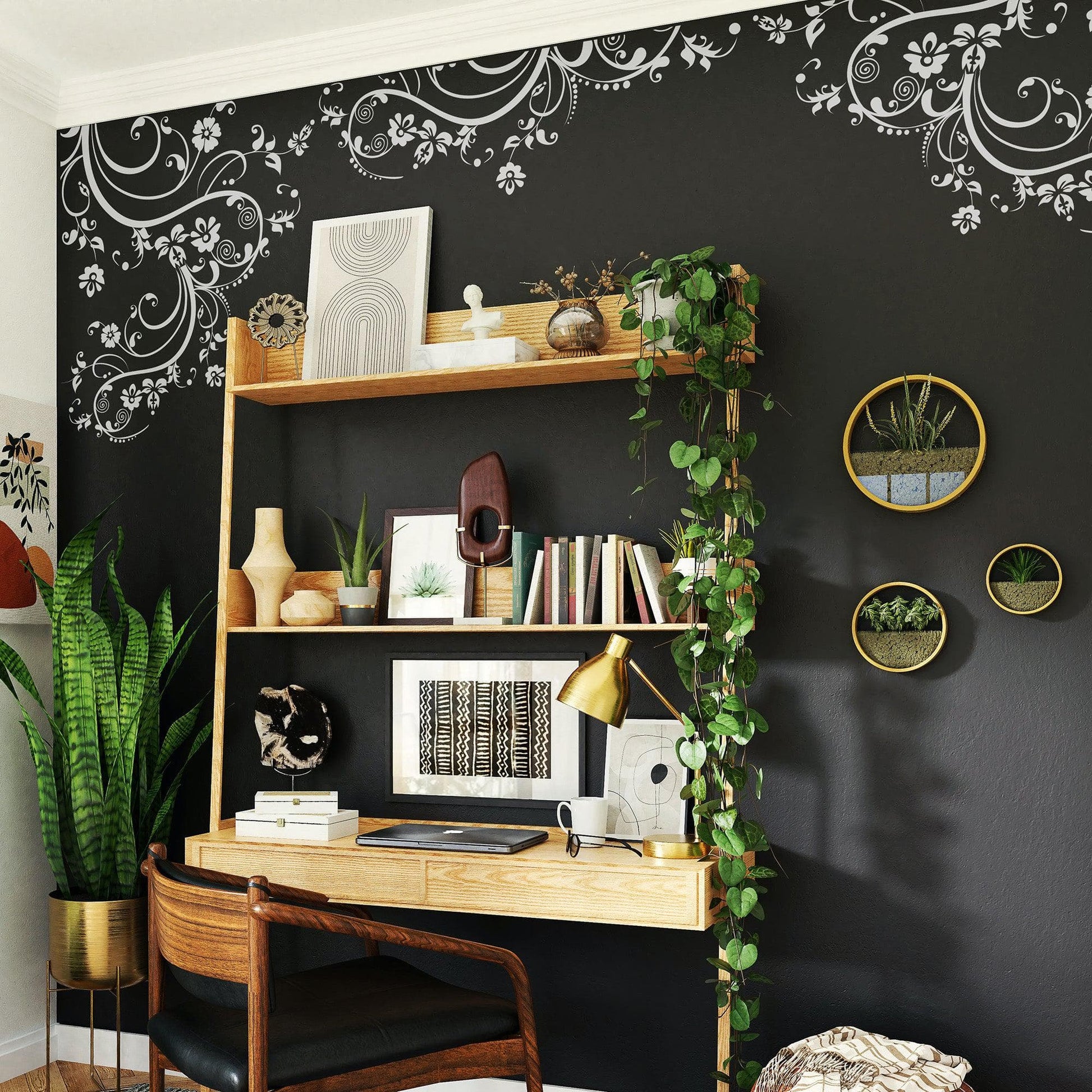 White swirling floral decals on a dark wall above a wooden desk.