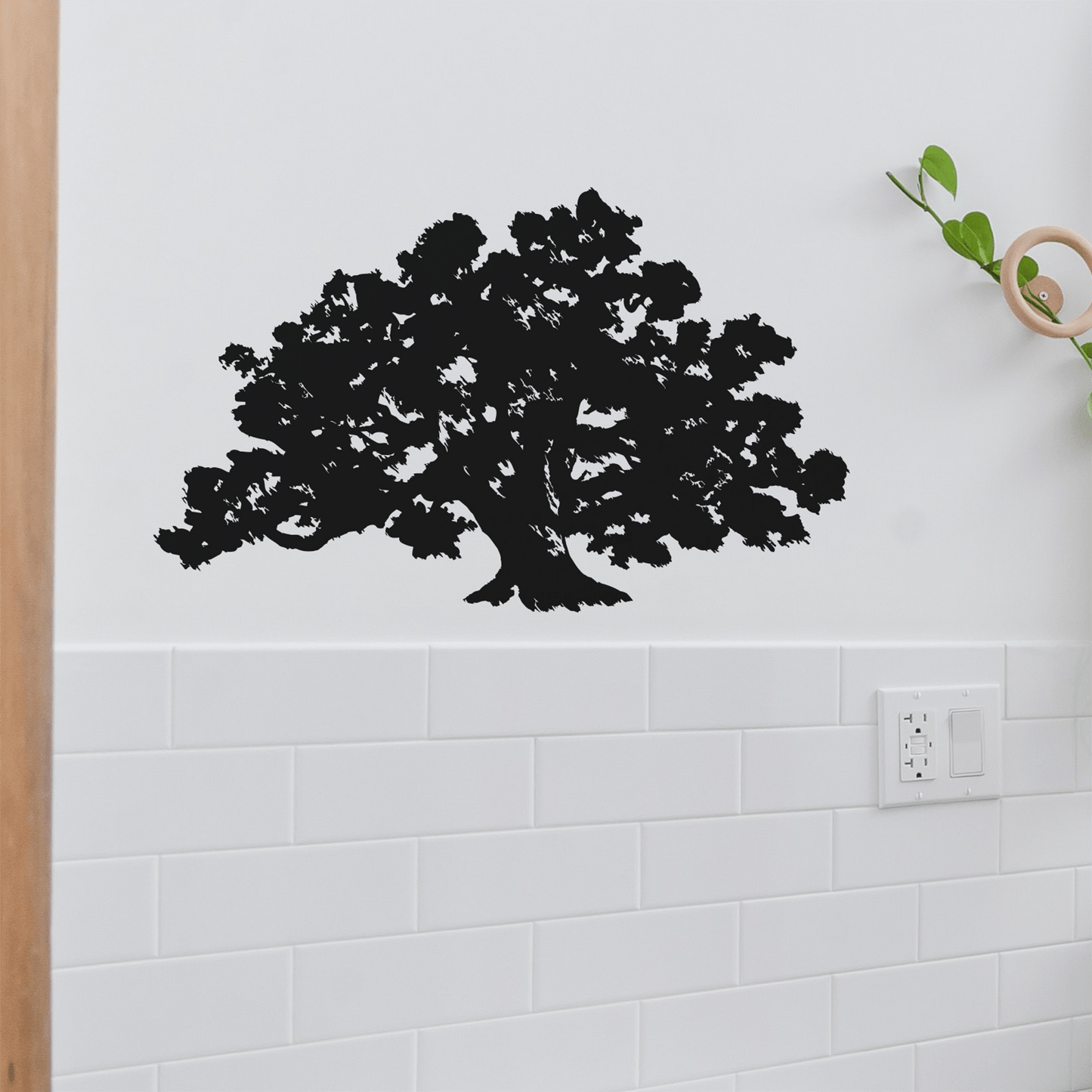 A black tree decal on a white wall.