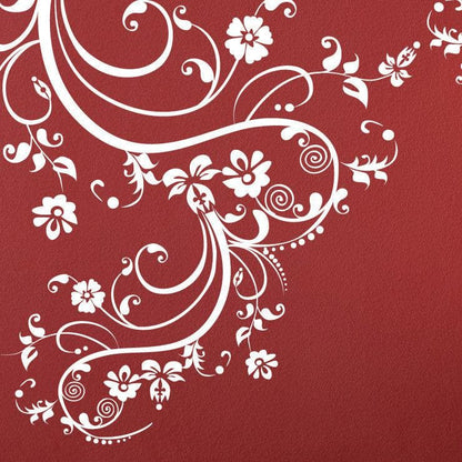 White swirling floral decals on a red wall.