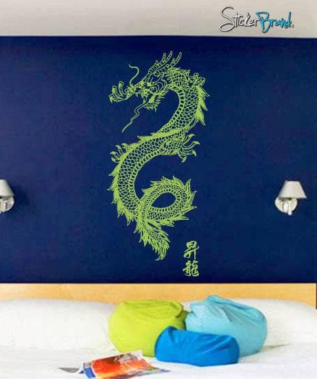 A green dragon decal on a blue wall above three pillows.