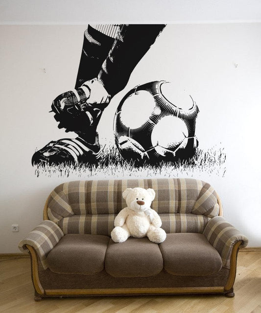 Soccer Football Action Feet Kicking Ball wall decal above a plaid sofa.