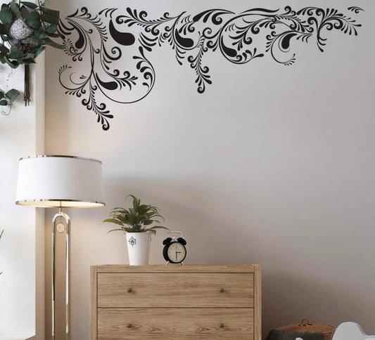 Swirl Ornaments Wall Decal Sticker on a white wall above a wooden dresser in a modern living room.