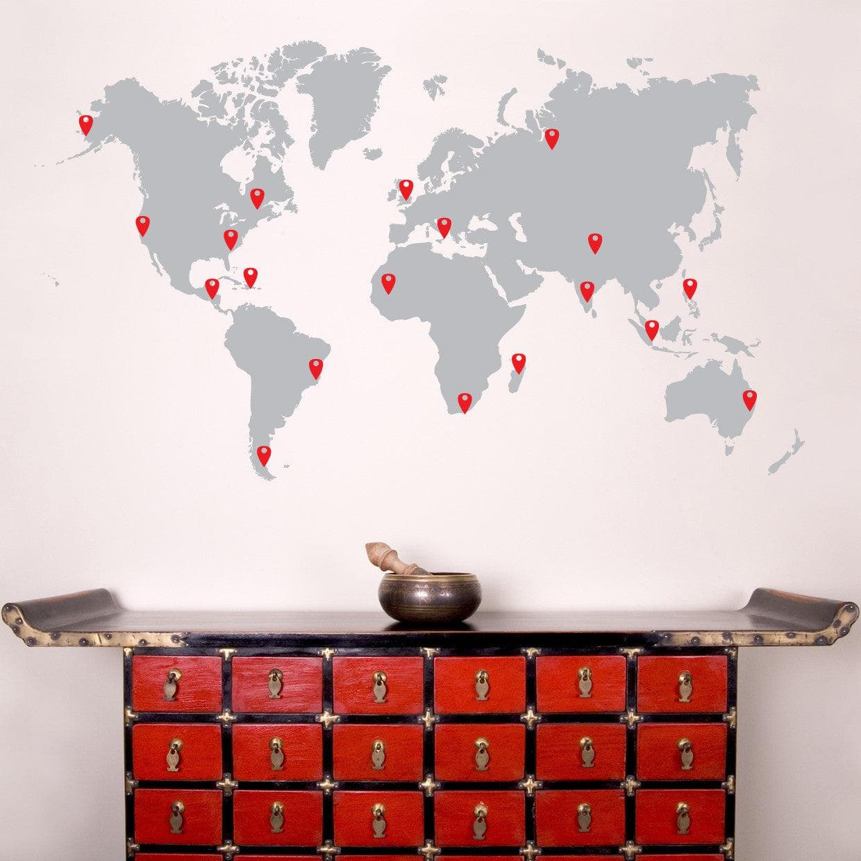 Living room wall adorned with black world map decal above a red closet.