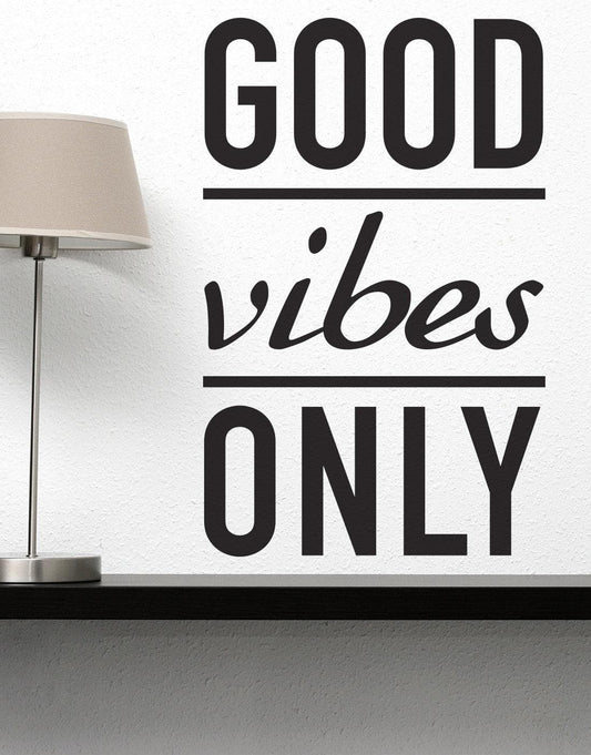 Good Vibes Only Motivational Vinyl Wall Decal on a wall over a desk beside a lamp.